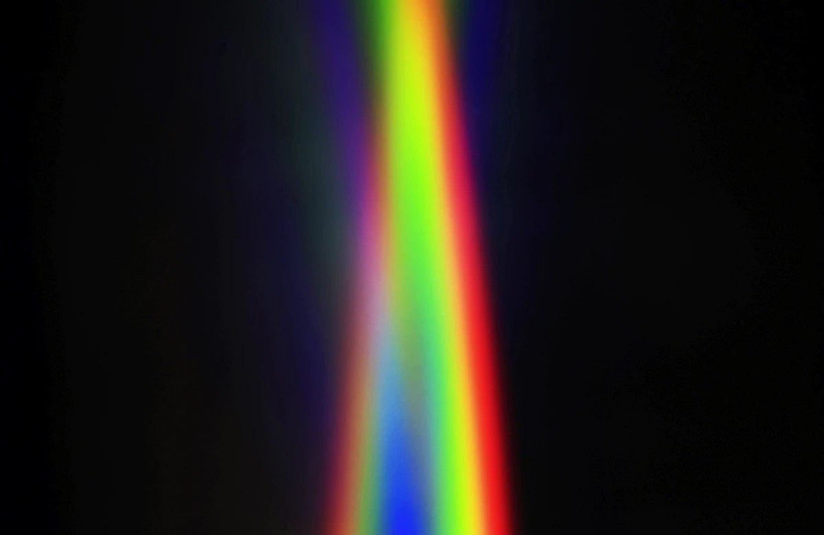Light refracted through glass prisms into coloured arcs
