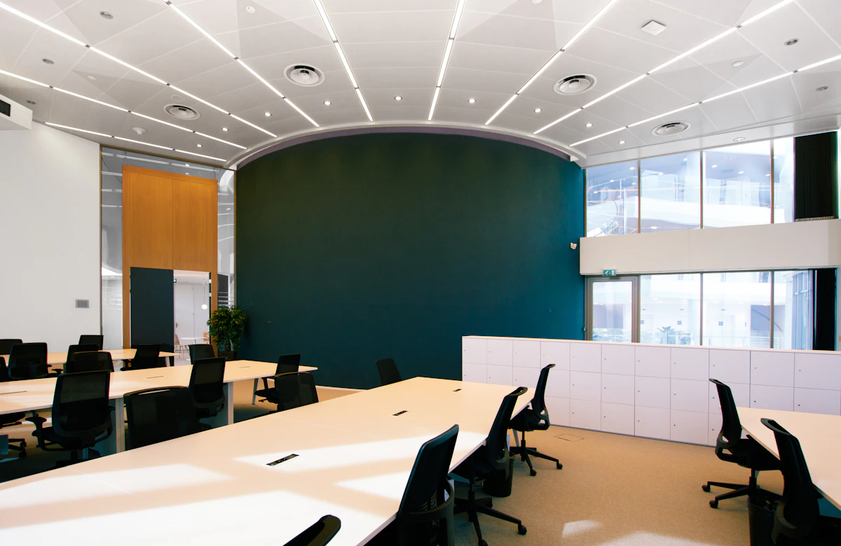 An empty meeting room with desks and chairs, an illustrative photograph